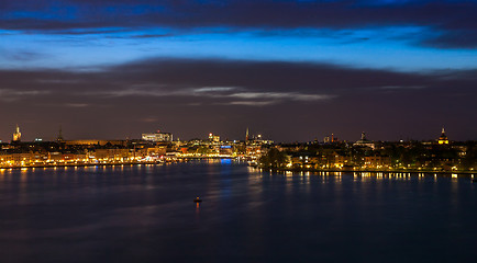 Image showing Stockholm at night with light reflection in water