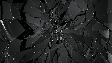 Image showing Pieces of splitted or cracked glass on black