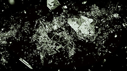 Image showing Pieces of splitted or broken glass on black