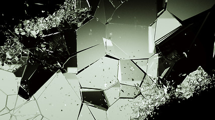 Image showing Cracked and damaged glass pieces on black