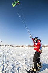 Image showing Kiteboarder with kite on the snow