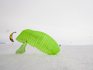 Image showing Kiteboarder with kite on the snow