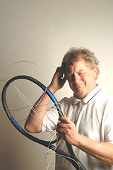 Image showing man with tennis frame and strings