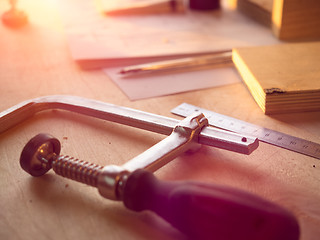 Image showing Real woodworking shop: clamps holding workpiece gluing, close-up