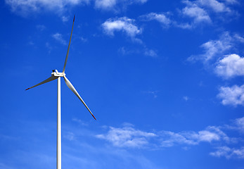 Image showing Wind turbine and blue sky with clouds