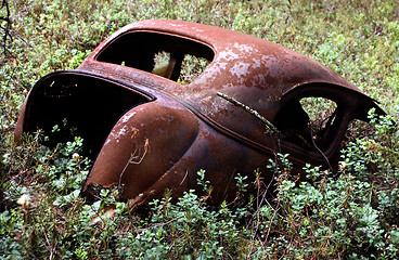 Image showing Old rusty car in disintegration.