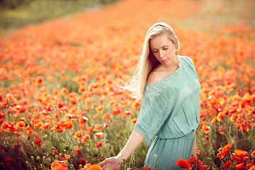 Image showing Beautiful woman on poppy flower field