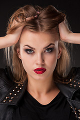 Image showing ortrait of beautiful model with long blond hair on black background