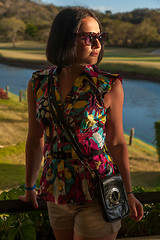 Image showing Young woman in sunglasses enjoying summer breeze at beach. 