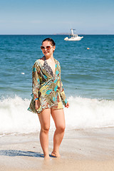 Image showing woman walking away on the beach