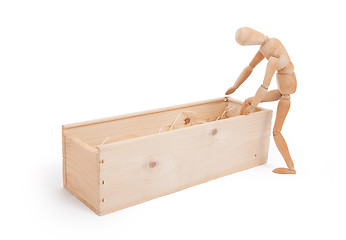 Image showing Wood figure mannequin stepping in a wooden box