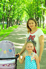 Image showing woman with baby in perambulator and elder daughter