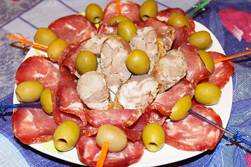 Image showing meat cutting into pieces and olives