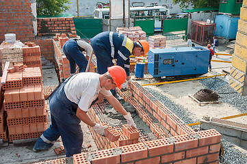Image showing Team of bricklayers on house construction