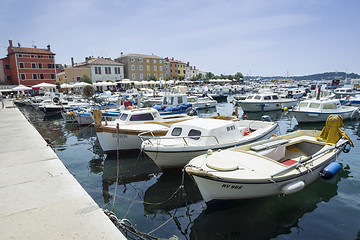 Image showing Moored boats with city promenade of Rovinj in background