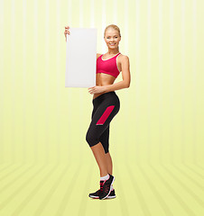 Image showing sportswoman with white blank board