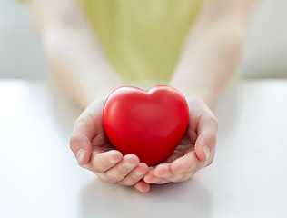 Image showing close up of child hands holding red heart