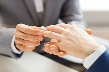 Image showing close up of male gay couple hands and wedding ring