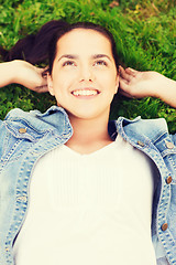 Image showing smiling young girl lying on grass