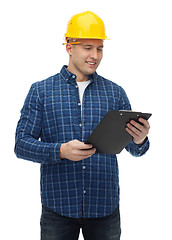 Image showing smiling man in helmet with clipboard
