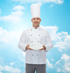 Image showing happy male chef cook showing empty plate