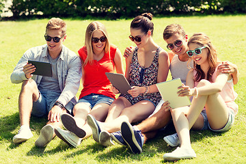 Image showing smiling friends with tablet pc computers in park