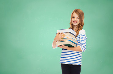 Image showing happy little student girl with many books