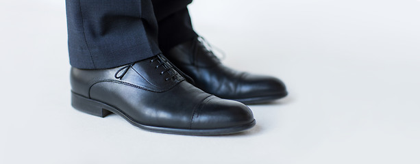 Image showing close up of man legs in elegant shoes with laces