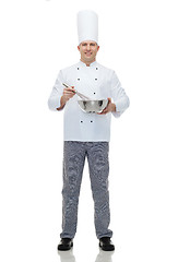 Image showing happy male chef cook whipping something with whisk