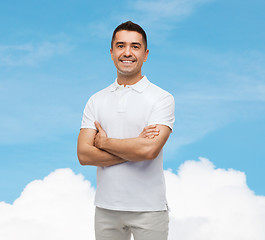 Image showing smiling man in white t-shirt with crossed arms