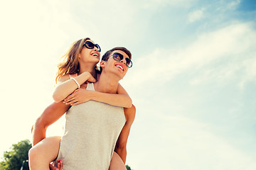 Image showing smiling couple having fun over sky background