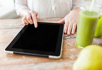 Image showing close up of woman hands tablet pc and fruit juice