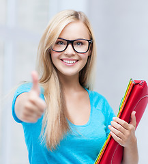 Image showing smiling student with folders