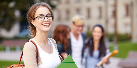 Image showing happy teenage students with school folders