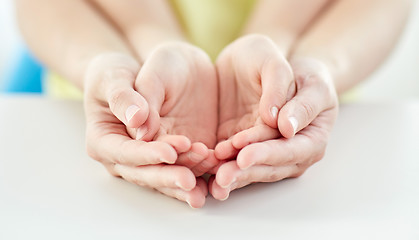 Image showing close up of woman and girl with cupped hands