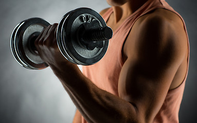 Image showing close up of young man with dumbbell