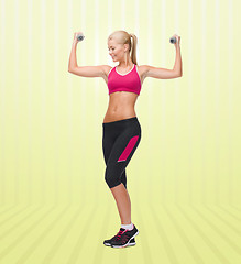 Image showing young sporty woman with dumbbells