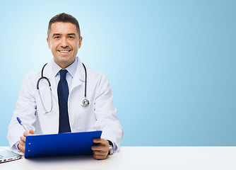 Image showing happy doctor with clipboard over blue background