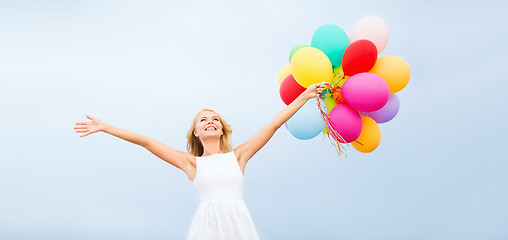 Image showing woman with colorful balloons outside