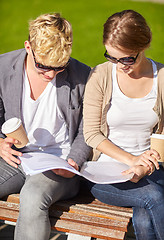 Image showing happy student couple with notebook and coffee