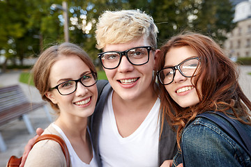 Image showing happy teenage students in eyeglasses at campus