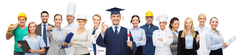 Image showing happy bachelor with diploma over professionals