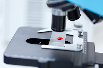 Image showing close up of microscope and blood sample in lab