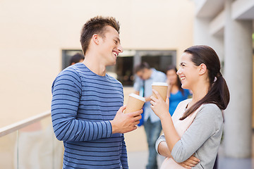 Image showing group of smiling students with paper coffee cups