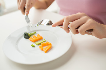 Image showing close up of woman hands eating vegetables