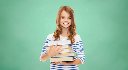 Image showing happy little student girl with many books