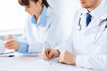 Image showing doctor and nurse writing prescription paper
