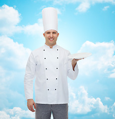 Image showing happy male chef cook showing empty plate