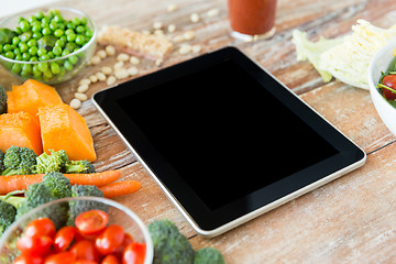 Image showing close up of blank tablet pc screen and vegetables