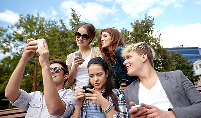 Image showing students or teenagers with smartphones at campus